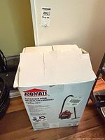 Boxed Jobmate vacuum showing open top
