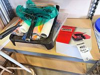 Lot overview showing sander box, paint tray with tools