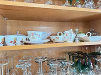 Shelf view showing Tuscan floral teacup, saucer, plate, sugar bowl, creamer and two Evesham cherry cups