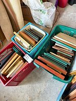 Two crates filled with assorted picture frames viewed from above