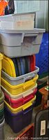 stack of multicolored totes with lids