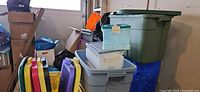 Stacked plastic totes and lids in garage setting