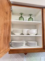 Cabinet view showing plates, bowls, and goblets