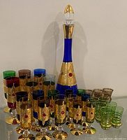 Full set showing decanter, flutes, tumblers and shot glasses