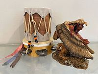 Drum with ribbons and jingles alongside spirit dancer figurine