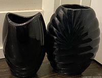 Both black ceramic vases side by side