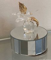 Music box front view showing mirrored base and glass bird