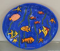 Front view of oval blue Talavera plate with fish motif