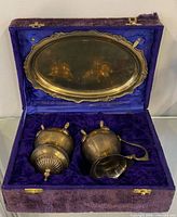 Set inside open purple velvet box showing tray in lid and two brass vessels