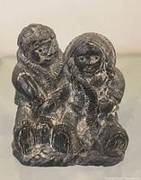 Front view of the A Wolf Original seated Indigenous couple figurine