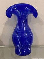 Front view of cobalt blue ruffled art glass vase