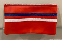 Front view of red vinyl pencil case with blue and white stripes