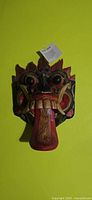 Frontal view of wood Barong mask showing colors and features