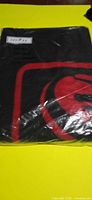 Front view of sealed black blanket showing red Dodge logo