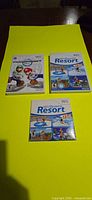 Front view of three Nintendo Wii cases: Mario Kart Wii, Wii Sports Resort, Wii Sports Resort sleeve