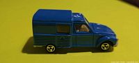 Left side view of blue Majorette Acadiane van