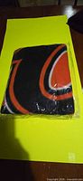 Front view of sealed BC Lions fleece throw blanket showing folded logo section