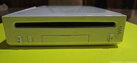 Front view of white Nintendo Wii console showing disc slot and buttons