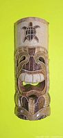 Front view of carved wooden tiki mask showing overall design