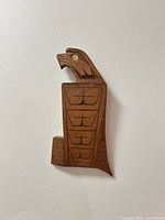 Front view of carved wooden eagle plaque