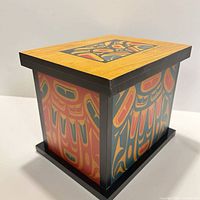 Three-quarter view of painted spirit box showing two decorated sides and lid