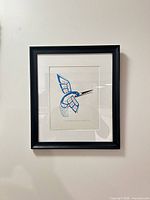 Full view of framed hummingbird artwork on wall