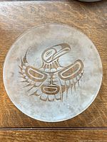 Full view of 10" transparent glass plate showing etched eagle design