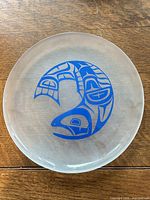 Full view of transparent plate showing blue salmon design