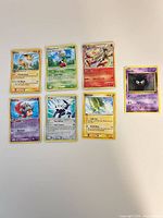 All seven Pokémon cards laid out