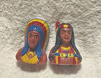 Front view of both plastic shakers, chief and maiden busts