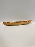 Side profile of wooden canoe model showing exterior hull