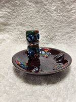 Top oblique view showing ashtray, totem figure, painted motifs