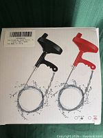 Retail box showing product images of drain auger variants