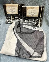 Front view of two packaged shams and folded bed skirt