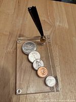 Top view showing embedded coins and pen mount