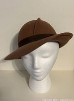 Front view of brown wool felt cloche hat on mannequin head