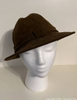 Front view of brown faux suede hat on mannequin head