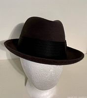 Front left view of charcoal gray fedora on display head showing crown shape and brim
