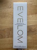 Front view of Eve Lom Radiance Face Oil boxed product