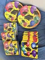 Graduation-themed napkins and plates showing graphics and quantities