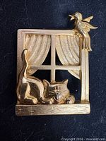 Front view showing cat, bird, window design