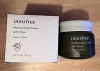 Front view of jar and box showing product name and volume