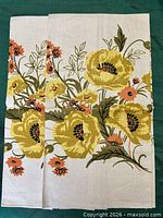 Two folded floral linen kitchen towels