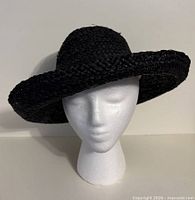 Front view of black straw sun hat on mannequin head