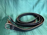 Three rolled leather belts showing overall appearance and colors