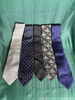 Front view of five silk neckties displayed side by side