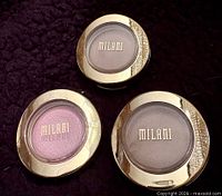 Front view of three Milani eyeshadow compacts showing colors