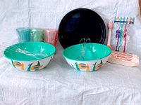 group shot showing bowls, cups, tray, utensils, hot dog boats, straws