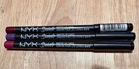 Three NYX Suede Matte Lip Liner pencils side-by-side showing barrel design and color ends