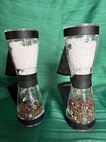Front view of both grinders showing salt and pepper contents